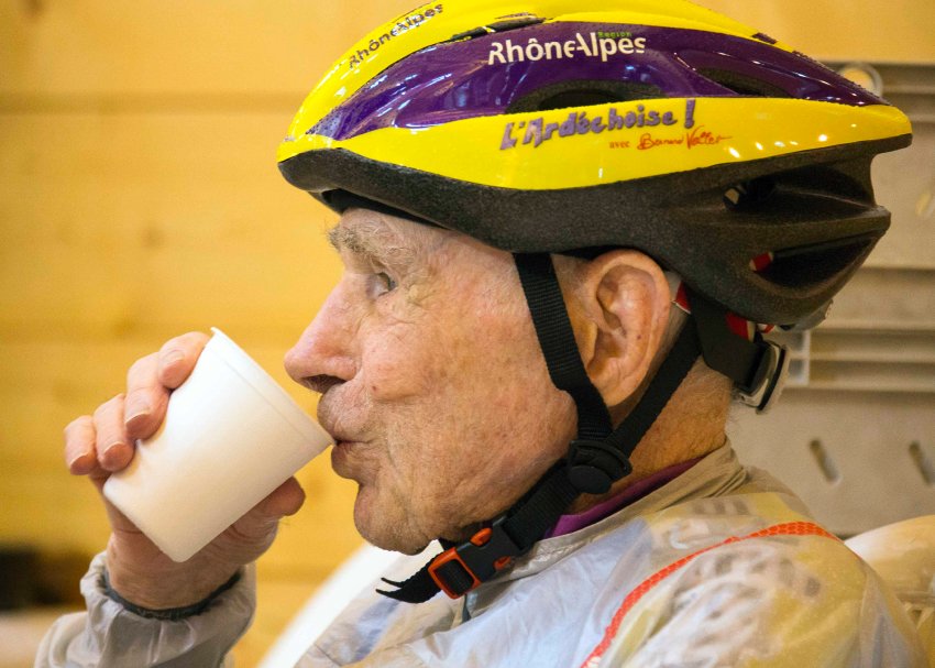 French cyclist Robert Marchand, 103 years-old, drinks a beverage before riding the Robert Marchand pass near Saint-Felicien